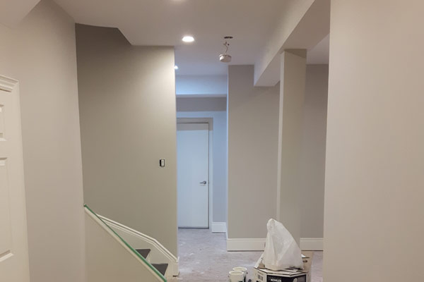 Basement finished with light colours and white ceiling.
