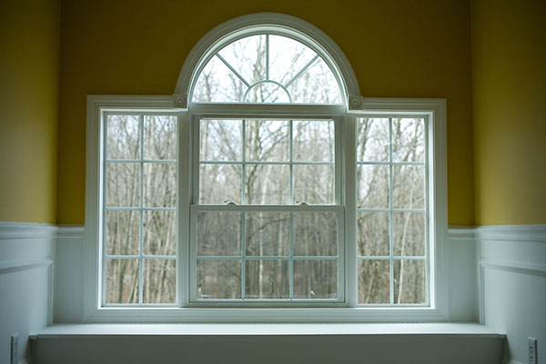 Window with white trims and mustard colour painted walls