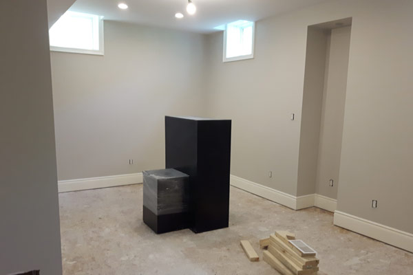 basement rool with white baseboards