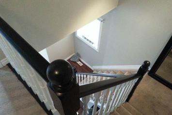 Stairs with white spindles and black stained tops